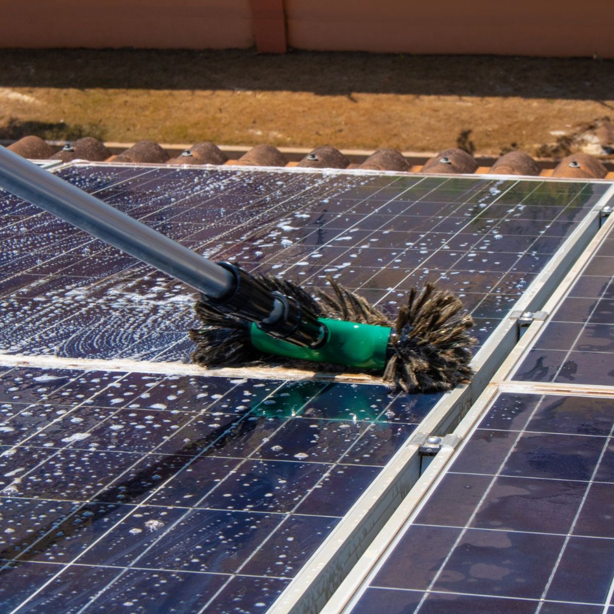 man cleaning solar panels