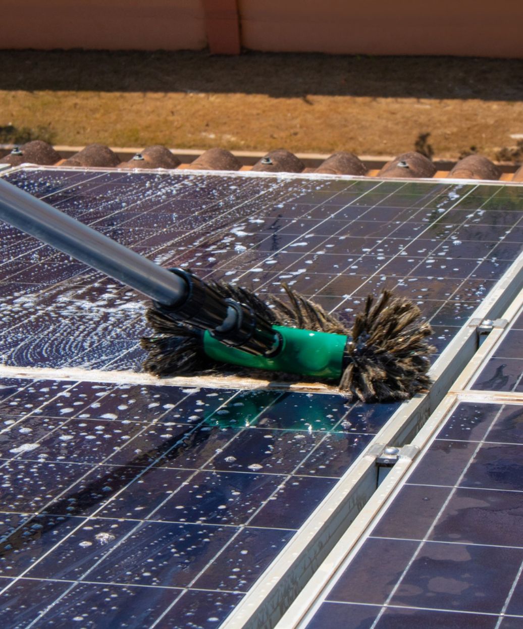 solar panel being cleaned with a brush