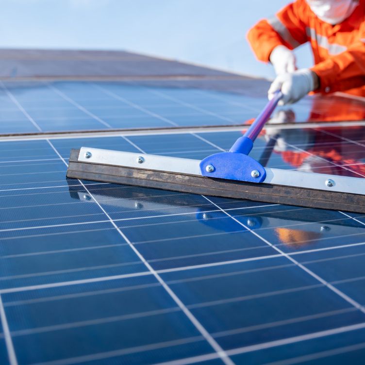 man cleaning a solar panel